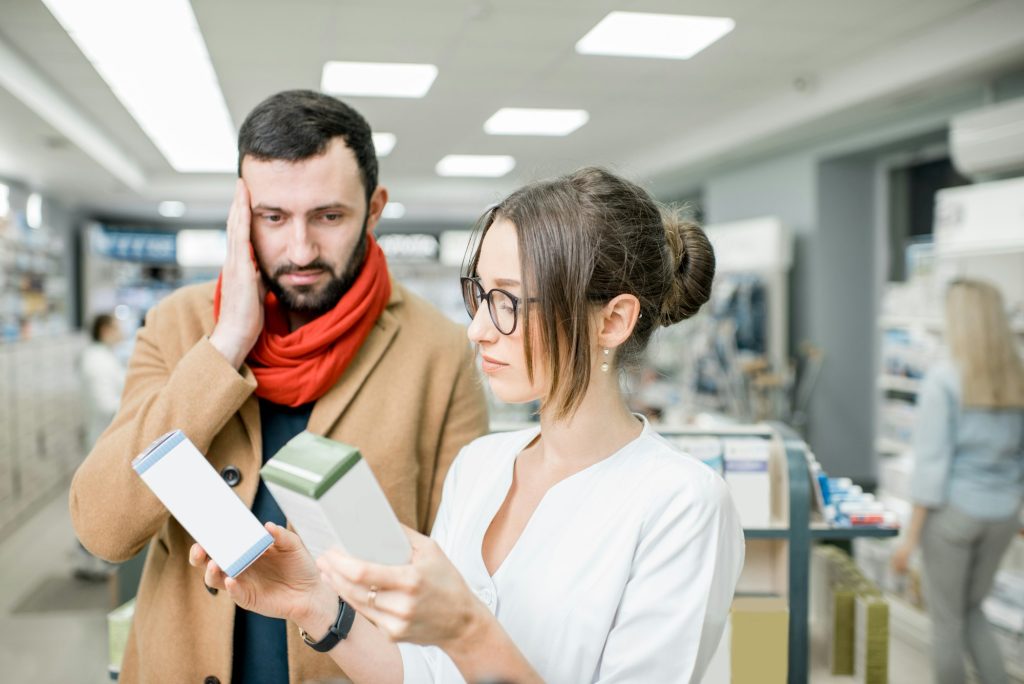 Pharmacist with client in the pharmacy store